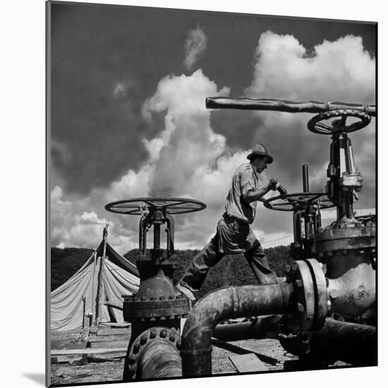 Worker Opening up a Pipeline to Let the Oil Flow-Thomas D^ Mcavoy-Mounted Photographic Print