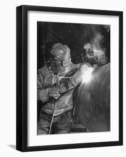 Worker Welding Pipe Used in Natural Gas Pipeline at World's Biggest Coal Fueled Generating Plant-Margaret Bourke-White-Framed Photographic Print