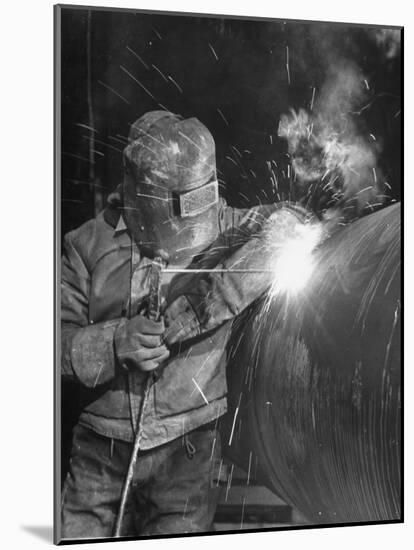 Worker Welding Pipe Used in Natural Gas Pipeline at World's Biggest Coal Fueled Generating Plant-Margaret Bourke-White-Mounted Photographic Print