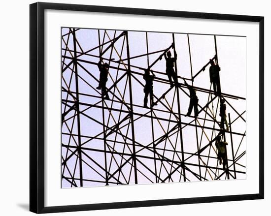 Workers Assemble the Frame of an Advertising Billboard Alongside a Bangkok Expressway-null-Framed Photographic Print