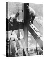 Workers balancing on steel beam above streets during construction of the Manhattan Company Building-Arthur Gerlach-Stretched Canvas