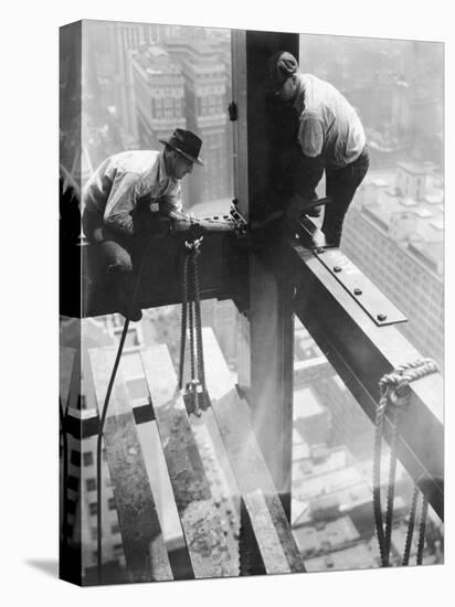 Workers balancing on steel beam above streets during construction of the Manhattan Company Building-Arthur Gerlach-Stretched Canvas