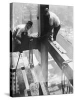 Workers balancing on steel beam above streets during construction of the Manhattan Company Building-Arthur Gerlach-Stretched Canvas