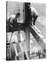 Workers balancing on steel beam above streets during construction of the Manhattan Company Building-Arthur Gerlach-Stretched Canvas