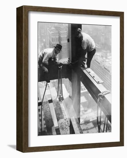 Workers balancing on steel beam above streets during construction of the Manhattan Company Building-Arthur Gerlach-Framed Photographic Print