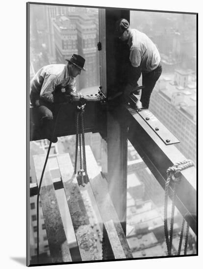 Workers balancing on steel beam above streets during construction of the Manhattan Company Building-Arthur Gerlach-Mounted Photographic Print