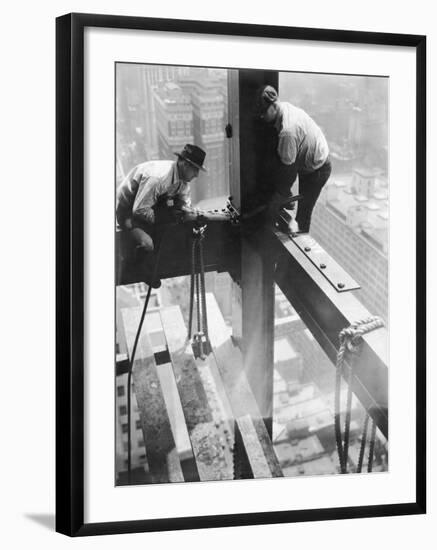 Workers balancing on steel beam above streets during construction of the Manhattan Company Building-Arthur Gerlach-Framed Photographic Print