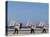 Workers Carry Beach Chairs Along the Beach of St. Peter-Ording at the North Sea, Northern Germany-null-Stretched Canvas