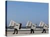 Workers Carry Beach Chairs Along the Beach of St. Peter-Ording at the North Sea, Northern Germany-null-Stretched Canvas