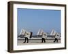 Workers Carry Beach Chairs Along the Beach of St. Peter-Ording at the North Sea, Northern Germany-null-Framed Photographic Print