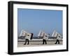 Workers Carry Beach Chairs Along the Beach of St. Peter-Ording at the North Sea, Northern Germany-null-Framed Photographic Print