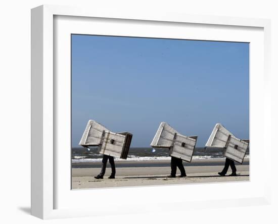 Workers Carry Beach Chairs Along the Beach of St. Peter-Ording at the North Sea, Northern Germany-null-Framed Photographic Print