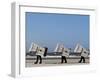 Workers Carry Beach Chairs Along the Beach of St. Peter-Ording at the North Sea, Northern Germany-null-Framed Photographic Print