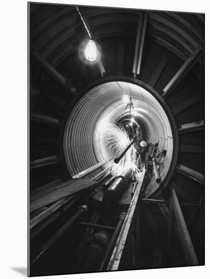 Workers Connecting Sections of Water Pipe in Tunnel-Ralph Crane-Mounted Photographic Print