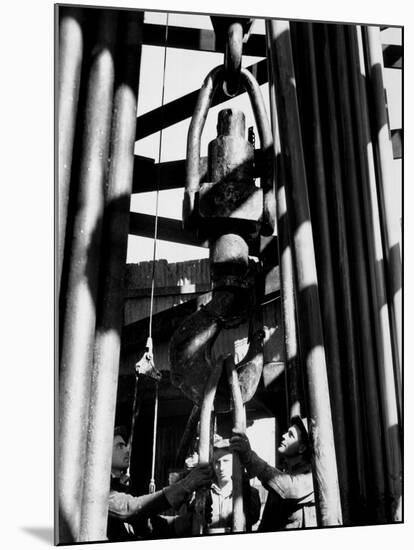 Workers Lower Pipe into Oil Well Inside Rig in a Texaco Oil Field-Margaret Bourke-White-Mounted Photographic Print