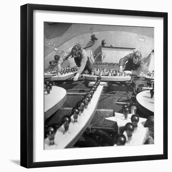 Workers Restoring Lightbulbs in a Sign-William Sumits-Framed Photographic Print
