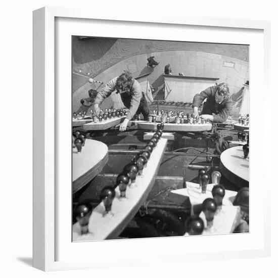 Workers Restoring Lightbulbs in a Sign-William Sumits-Framed Photographic Print