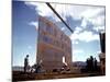 Workers Watching as Steel Beam is Raised High Above During Sub Assembling of Ship at Shipyard-Hansel Mieth-Mounted Photographic Print