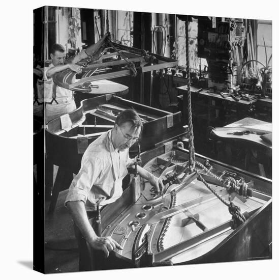 Workmen Installing Steel String Frames Into Grand Piano Cabinets at Steinway Piano Factory-Margaret Bourke-White-Stretched Canvas