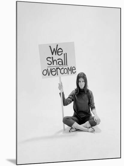 Writer Gloria Steinem Sitting on Floor with Sign "We Shall Overcome" Regarding Pop Culture-Yale Joel-Mounted Premium Photographic Print