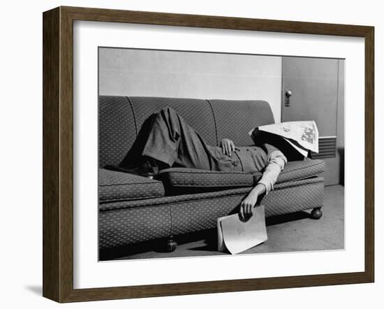 Writer Niven Busch Lying on Sofa with Newspaper over His Face as He Takes Nap from Screenwriting-Paul Dorsey-Framed Photographic Print