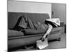 Writer Niven Busch Lying on Sofa with Newspaper over His Face as He Takes Nap from Screenwriting-Paul Dorsey-Mounted Photographic Print