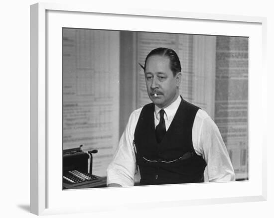 Writer Robert Benchley, Sitting at His Desk with a Small Wade of Paper in His Mouth-Bernard Hoffman-Framed Premium Photographic Print