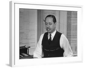 Writer Robert Benchley, Sitting at His Desk with a Small Wade of Paper in His Mouth-Bernard Hoffman-Framed Premium Photographic Print