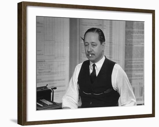 Writer Robert Benchley, Sitting at His Desk with a Small Wade of Paper in His Mouth-Bernard Hoffman-Framed Premium Photographic Print