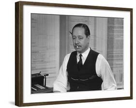 Writer Robert Benchley, Sitting at His Desk with a Small Wade of Paper in His Mouth-Bernard Hoffman-Framed Premium Photographic Print