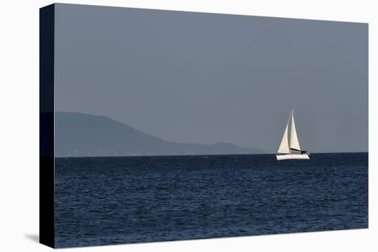 Yacht. Sailing Boat. Sailboat White Sail Boat between Blue Sky and Dark Blue Sea. an Island on Fore-PROtoys-Stretched Canvas