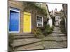 Yellow and Blue Doors on Houses in the Opening, Robin Hood's Bay, England-Pearl Bucknall-Mounted Photographic Print