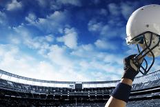 Raised Football Helmet at an American Football Stadium-yobro-Framed Photographic Print