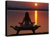 Yoga on a Saddle Bench Watching the Sun Go Down across the Zambesi River, Zambia-John Warburton-lee-Stretched Canvas