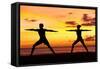 Yoga People Training and Meditating in Warrior Pose Outside by Beach at Sunrise or Sunset-Maridav-Framed Stretched Canvas