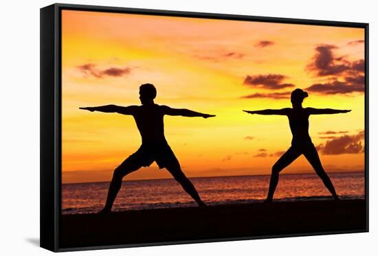 Yoga People Training and Meditating in Warrior Pose Outside by Beach at Sunrise or Sunset-Maridav-Framed Stretched Canvas