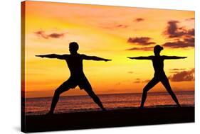 Yoga People Training and Meditating in Warrior Pose Outside by Beach at Sunrise or Sunset-Maridav-Stretched Canvas