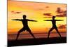 Yoga People Training and Meditating in Warrior Pose Outside by Beach at Sunrise or Sunset-Maridav-Mounted Photographic Print