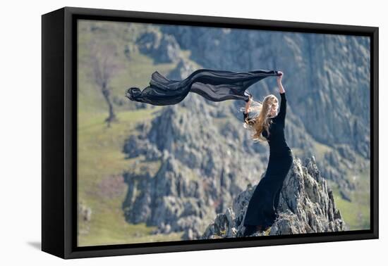 Youn Woman Wearing Black Dress Outdoor on Rocks-geanina bechea-Framed Stretched Canvas