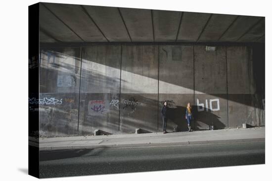 Young Adult Couple Standing in Underpass-Clive Nolan-Stretched Canvas