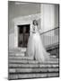 Young Adult Female in Long Wedding Dress Standing on Steps-Steven Boone-Mounted Photographic Print