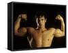 Young Adult Male Posing with Arms Flexed-Chris Trotman-Framed Stretched Canvas