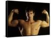 Young Adult Male Posing with Arms Flexed-Chris Trotman-Framed Stretched Canvas