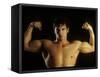 Young Adult Male Posing with Arms Flexed-Chris Trotman-Framed Stretched Canvas