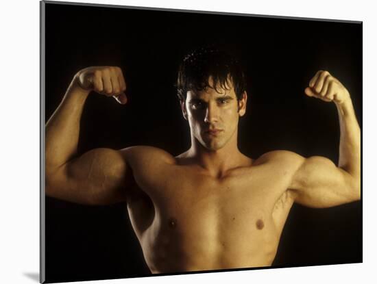 Young Adult Male Posing with Arms Flexed-Chris Trotman-Mounted Photographic Print