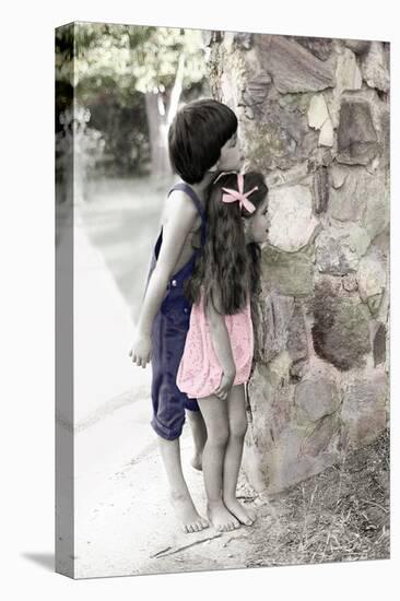Young Boy and Girl Peeking around a Stone Wall.-Nora Hernandez-Stretched Canvas