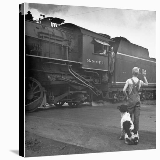 Young Boy and His Dog Standing at the Crossing as a Train Rides Through-Myron Davis-Stretched Canvas