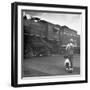 Young Boy and His Dog Standing at the Crossing as a Train Rides Through-Myron Davis-Framed Photographic Print