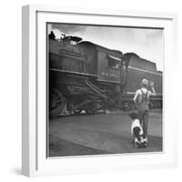 Young Boy and His Dog Standing at the Crossing as a Train Rides Through-Myron Davis-Framed Photographic Print
