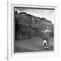 Young Boy and His Dog Standing at the Crossing as a Train Rides Through-Myron Davis-Framed Photographic Print